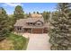 Charming two-story home featuring a three-car garage, mature trees, and a well-maintained front yard at 8015 Lt William Clark Rd, Parker, CO 80134