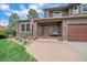 Inviting front entrance features a cozy bench, stone accents, and well-maintained landscaping at 8015 Lt William Clark Rd, Parker, CO 80134