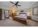 Spacious main bedroom featuring a fan, large bed and many windows with stylish shutters and a doorway at 8015 Lt William Clark Rd, Parker, CO 80134