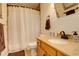 Full bathroom featuring a granite countertop and decorative shower curtain at 709 S Depew St, Lakewood, CO 80226