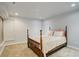 Bright bedroom featuring a wooden four poster bed and neutral decor at 709 S Depew St, Lakewood, CO 80226