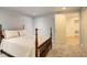 Bedroom with neutral carpet, view of another room and a large four poster bed at 709 S Depew St, Lakewood, CO 80226