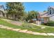 Landscaped community green space with retaining wall, steps, and walking path at 709 S Depew St, Lakewood, CO 80226