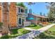 Exterior showcasing well-maintained townhomes with brick accents and landscaped front yards at 709 S Depew St, Lakewood, CO 80226