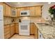 Well-lit kitchen featuring granite countertops and stainless steel appliances at 709 S Depew St, Lakewood, CO 80226
