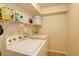 Functional laundry room with appliances and shelving for storage at 709 S Depew St, Lakewood, CO 80226