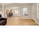 Bright living room with hardwood floors, open to kitchen and view of front door at 709 S Depew St, Lakewood, CO 80226