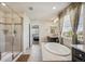 Bright bathroom featuring a soaking tub, walk-in shower, and modern fixtures, creating a spa-like experience at 19471 W 59Th Ave, Golden, CO 80403