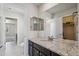 Bathroom features a granite countertop vanity with double sinks and mirrors, creating a functional and stylish space at 19471 W 59Th Ave, Golden, CO 80403