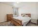Cozy bedroom boasts natural light, neutral tones, and a wood-frame bed at 19471 W 59Th Ave, Golden, CO 80403