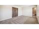 Expansive bedroom with carpet flooring, sliding barn door, and ensuite bathroom at 19471 W 59Th Ave, Golden, CO 80403