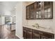 Butler's pantry with dark wood cabinets and granite countertop, adjacent to kitchen at 19471 W 59Th Ave, Golden, CO 80403