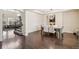 Dining room with dark hardwood floors, modern light fixture, and open view to the living room at 19471 W 59Th Ave, Golden, CO 80403