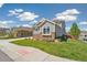 Attractive two-story home featuring gray siding, stone accents, and lush landscaping at 19471 W 59Th Ave, Golden, CO 80403