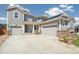 Gray two-story home featuring a two-car garage, complemented by well-kept landscaping and stone accents at 19471 W 59Th Ave, Golden, CO 80403