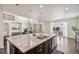 Open floor plan shows a huge kitchen island with view of the living room and fireplace beyond at 19471 W 59Th Ave, Golden, CO 80403
