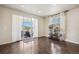 A bright living room boasts hardwood floors, access to a balcony, and neighborhood views at 19471 W 59Th Ave, Golden, CO 80403