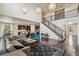 Spacious living room boasts high ceilings, large windows, dark hardwood floors, and an open staircase at 19471 W 59Th Ave, Golden, CO 80403