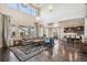 Bright living room with high ceilings, large windows, dark hardwood floors, and open layout to kitchen at 19471 W 59Th Ave, Golden, CO 80403