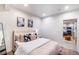 Bright bedroom with modern decor and an open doorway to the kitchen at 10669 Worchester Dr, Commerce City, CO 80022