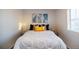 Bright bedroom with decorative pillows and modern art above the headboard at 10669 Worchester Dr, Commerce City, CO 80022