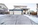 Inviting two-story home boasts a large driveway and attached two-car garage at 10669 Worchester Dr, Commerce City, CO 80022