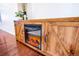 A rustic wooden entertainment center complete with an electric fireplace at 10669 Worchester Dr, Commerce City, CO 80022