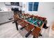 Foosball table in a game room with a kitchenette in the background at 10669 Worchester Dr, Commerce City, CO 80022