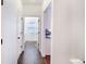 Hallway leads to the laundry room and kitchen, featuring tile and hardwood floors at 10669 Worchester Dr, Commerce City, CO 80022