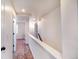 Bright hallway featuring neutral tones and carpet, leading to bedrooms at 10669 Worchester Dr, Commerce City, CO 80022