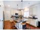 Modern kitchen island featuring a marble countertop and pendant lighting at 10669 Worchester Dr, Commerce City, CO 80022