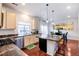 Modern kitchen featuring stainless steel appliances, an island with bar seating, and an open layout at 10669 Worchester Dr, Commerce City, CO 80022