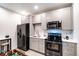 The kitchenette offers sleek gray cabinets and stainless steel appliances at 10669 Worchester Dr, Commerce City, CO 80022