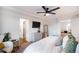 Well-lit main bedroom with a king bed, seating area, and en-suite bathroom at 10669 Worchester Dr, Commerce City, CO 80022