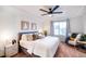 Bright main bedroom with a king bed, a sitting area, and neutral décor at 10669 Worchester Dr, Commerce City, CO 80022