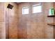 Modern tiled shower with square showerhead, dual windows and recessed shelf at 10669 Worchester Dr, Commerce City, CO 80022