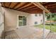A spacious covered back patio featuring sliding glass door access to the home and wooden decking at 3246 S Nucla St, Aurora, CO 80013