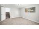 Finished basement space with neutral carpet, large window, and nearby access to the stairway at 3246 S Nucla St, Aurora, CO 80013