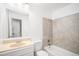 Well-lit bathroom featuring a vanity with ample storage and a tiled shower/tub combination at 3246 S Nucla St, Aurora, CO 80013