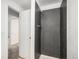 Modern bathroom featuring gray shower tile and a white door at 3246 S Nucla St, Aurora, CO 80013