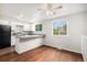 Bright kitchen featuring white cabinets and sleek countertops, bathed in natural light from a large window at 3246 S Nucla St, Aurora, CO 80013