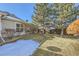 Backyard featuring a lawn, garden beds, fence, and mature landscaping at 10311 Adams Pl, Thornton, CO 80229