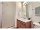 Bathroom featuring a vanity, sink, and a glass door shower enclosure at 10311 Adams Pl, Thornton, CO 80229