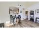 Bright dining area features a high table with wooden chairs, plus an open view to another room at 10311 Adams Pl, Thornton, CO 80229