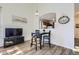 Dining area next to living room, arched doorway with a view into the kitchen, and modern decor at 10311 Adams Pl, Thornton, CO 80229