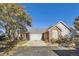 Charming two-story home featuring a brick and siding exterior, mature trees, and a two-car garage at 10311 Adams Pl, Thornton, CO 80229