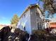Side view of a two-story home with siding, bright windows, and established landscaping at 10311 Adams Pl, Thornton, CO 80229