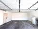 Spacious garage with an opener and white walls, ready to park vehicles or be used as storage at 10311 Adams Pl, Thornton, CO 80229