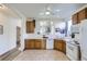 The kitchen overlooks the living room through an arch and has tile flooring and white appliances at 10311 Adams Pl, Thornton, CO 80229