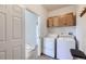 A well-equipped laundry room with washer, dryer, and cabinet storage space at 10311 Adams Pl, Thornton, CO 80229